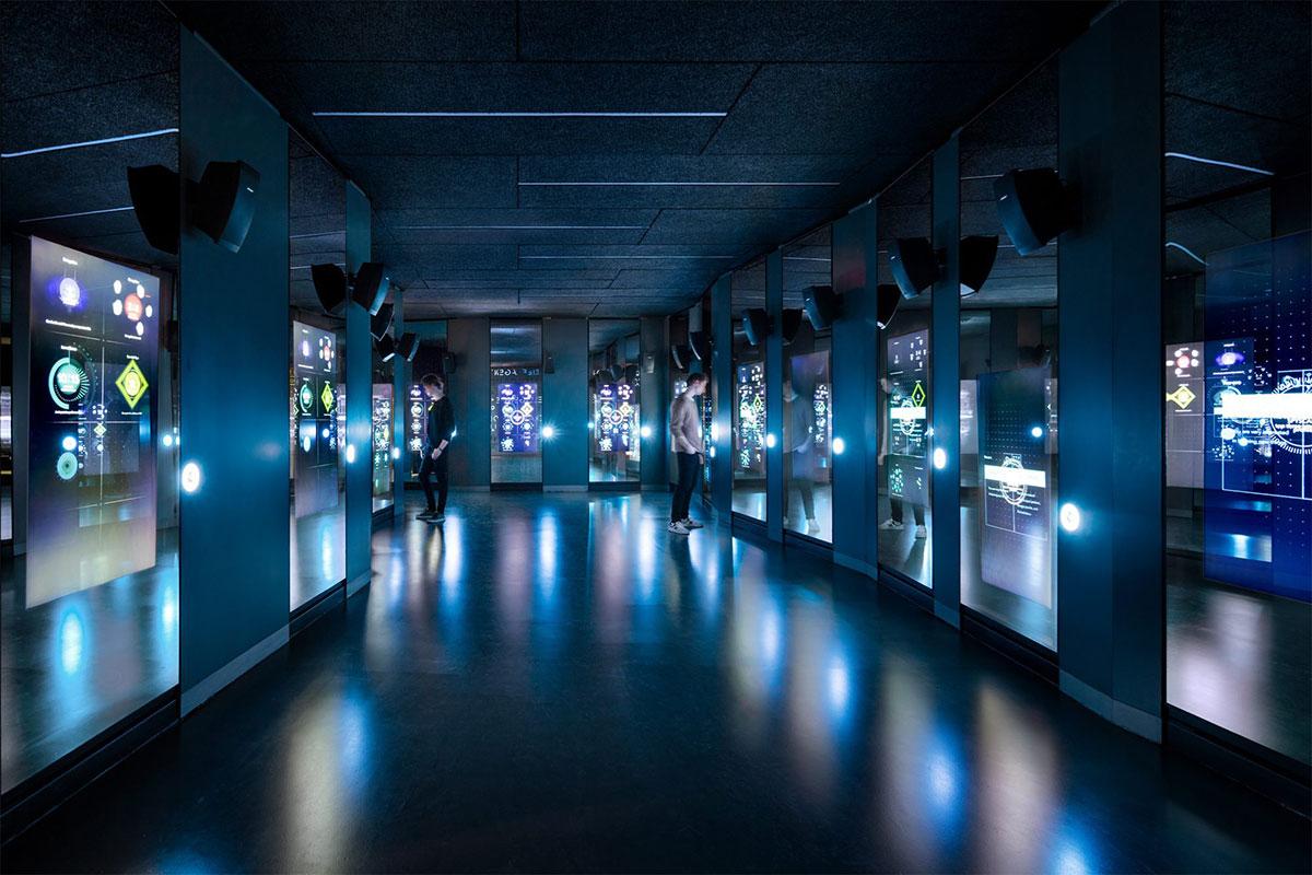 Neon hall with holographic images of objects in showcases